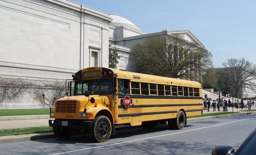 Yellow school bus near a Washington DC landmark