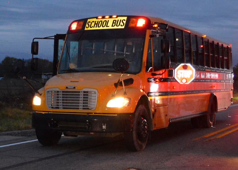 School bus stop-arm extended with flashing red lights